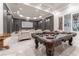 Elegant game room with pool table, theater seating, and marble floors at 3915 Muirfield Sq, Duluth, GA 30096