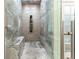 Large walk-in shower with glass enclosure and multiple shower heads at 3915 Muirfield Sq, Duluth, GA 30096