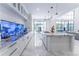 Modern kitchen with center island and French doors to backyard at 3915 Muirfield Sq, Duluth, GA 30096