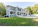 Large white house with manicured lawn and private backyard at 3915 Muirfield Sq, Duluth, GA 30096