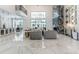 Two-story living room with a marble floor and large windows at 3915 Muirfield Sq, Duluth, GA 30096
