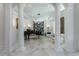 Elegant music room with marble flooring, a grand piano, and columns at 3915 Muirfield Sq, Duluth, GA 30096