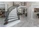 Elegant curved staircase with wrought iron railing at 3915 Muirfield Sq, Duluth, GA 30096