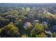 Aerial view of home near golf course and lush trees at 3915 Muirfield Sq, Duluth, GA 30096