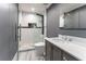 Modern bathroom with gray vanity and walk-in shower at 3915 Muirfield Sq, Duluth, GA 30096