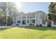 Grand white house with balconies and large green lawn at 3915 Muirfield Sq, Duluth, GA 30096