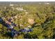 Aerial view showing house nestled in a wooded neighborhood at 3915 Muirfield Sq, Duluth, GA 30096