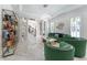 Green velvet sofas and marble floors feature in this living room at 3915 Muirfield Sq, Duluth, GA 30096