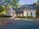 Community clubhouse with inviting front porch and landscaping at 3915 Muirfield Sq, Duluth, GA 30096