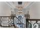 Grand staircase with ornate railing and chandelier at 3915 Muirfield Sq, Duluth, GA 30096