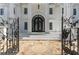 Ornate black iron gates open to a grand entrance with marble steps at 3915 Muirfield Sq, Duluth, GA 30096