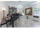 Elegant living room featuring a grand piano, marble floors, and large windows at 3915 Muirfield Sq, Duluth, GA 30096