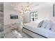 Bright main bedroom with marble floors, chandeliers, and French doors to balcony at 3915 Muirfield Sq, Duluth, GA 30096