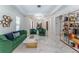 Spacious living area showcasing a green velvet sofa and marble flooring at 3915 Muirfield Sq, Duluth, GA 30096