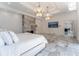 Grand main bedroom boasts marble floors, a fireplace, and views of the backyard at 3915 Muirfield Sq, Duluth, GA 30096