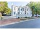 Grand white mansion with a long driveway and gated entry at 3915 Muirfield Sq, Duluth, GA 30096