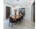 Formal dining room with a large wood table and marble floors at 3915 Muirfield Sq, Duluth, GA 30096