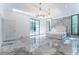 Luxurious main bedroom with marble floors, chandeliers, and French doors at 3915 Muirfield Sq, Duluth, GA 30096