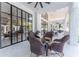 Covered patio with seating area and glass doors leading inside at 3915 Muirfield Sq, Duluth, GA 30096