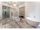 Luxury bathroom with marble floors, a large soaking tub and a walk in shower at 3915 Muirfield Sq, Duluth, GA 30096