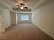 Large main bedroom with ceiling fan and carpet flooring at 5730 Calle Vista Dr # Bv001, Lithonia, GA 30058