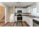 Modern kitchen with white cabinets, granite counters, and stainless steel appliances at 3891 Northstrand Dr, Decatur, GA 30035