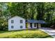 Renovated ranch home with yellow door and carport at 3900 Hilton Cts, Decatur, GA 30035
