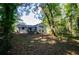 House and backyard with wooded area beyond at 3900 Hilton Cts, Decatur, GA 30035