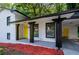 Bright white home with black accents and a yellow door at 3900 Hilton Cts, Decatur, GA 30035