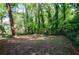 Large backyard bordered by trees and a fence at 3900 Hilton Cts, Decatur, GA 30035