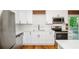 White shaker cabinets, stainless steel appliances, and wood floors at 3900 Hilton Cts, Decatur, GA 30035