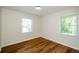 Simple bedroom with wood floors and two windows at 3900 Hilton Cts, Decatur, GA 30035