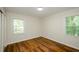 Bright bedroom with wood-look floors and two windows at 3900 Hilton Cts, Decatur, GA 30035