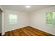 Bright bedroom with wood-look floors and two windows at 3900 Hilton Cts, Decatur, GA 30035