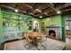 Green dining room features a wood paneled ceiling, stone fireplace and built-in shelving at 1273 Oakdale Ne Rd, Atlanta, GA 30307