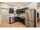 Modern kitchen with dark green cabinets, stainless steel appliances, and marble countertops at 1336 Mcclelland Ave, Atlanta, GA 30344