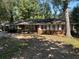 Brick ranch house with white shutters, and a large yard at 2132 River Rd, Ellenwood, GA 30294