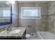 Updated bathroom with granite countertop, tile shower, and modern vanity at 2362 Manor Ave, Atlanta, GA 30344