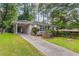Ranch house with driveway and carport, nestled amongst lush greenery at 2362 Manor Ave, Atlanta, GA 30344