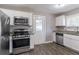 Updated kitchen with stainless steel appliances and granite countertops at 2362 Manor Ave, Atlanta, GA 30344