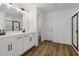 Double vanity bathroom with modern fixtures and frameless shower at 7276 Eton Ln, Locust Grove, GA 30248