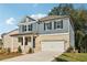 Two story home with gray siding and brick accents at 7276 Eton Ln, Locust Grove, GA 30248