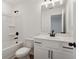 Clean bathroom, featuring white vanity, tub, and mirror at 7276 Eton Ln, Locust Grove, GA 30248