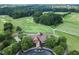 Aerial view of golf course clubhouse and surrounding landscape at 7276 Eton Ln, Locust Grove, GA 30248