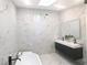 Luxury bathroom with marble walls, double vanity, and soaking tub at 5255 Buice Rd, Alpharetta, GA 30022