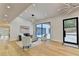 Modern living room with hardwood floors, large windows, and stylish furniture at 5255 Buice Rd, Alpharetta, GA 30022