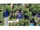 Aerial view of a house with a pool, driveway, and large lot surrounded by trees at 5255 Buice Rd, Alpharetta, GA 30022