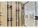 Stylish wine cellar featuring metal racks and wood paneling at 5255 Buice Rd, Alpharetta, GA 30022