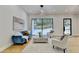Spacious living area featuring a cozy sitting area and sliding glass doors at 5255 Buice Rd, Alpharetta, GA 30022