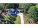 Aerial view of a house with a detached garage and long driveway at 5255 Buice Rd, Alpharetta, GA 30022